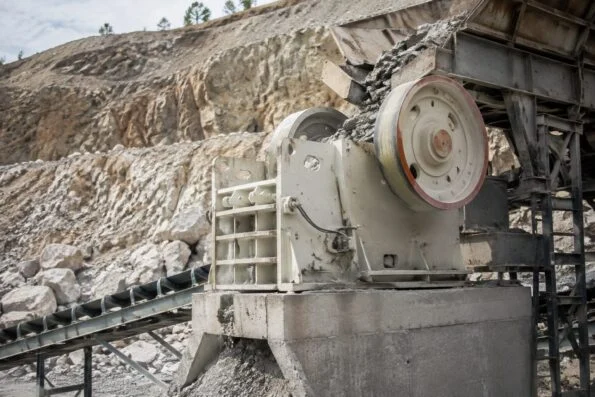 Jaw crusher operating at a quarry with stone being fed in